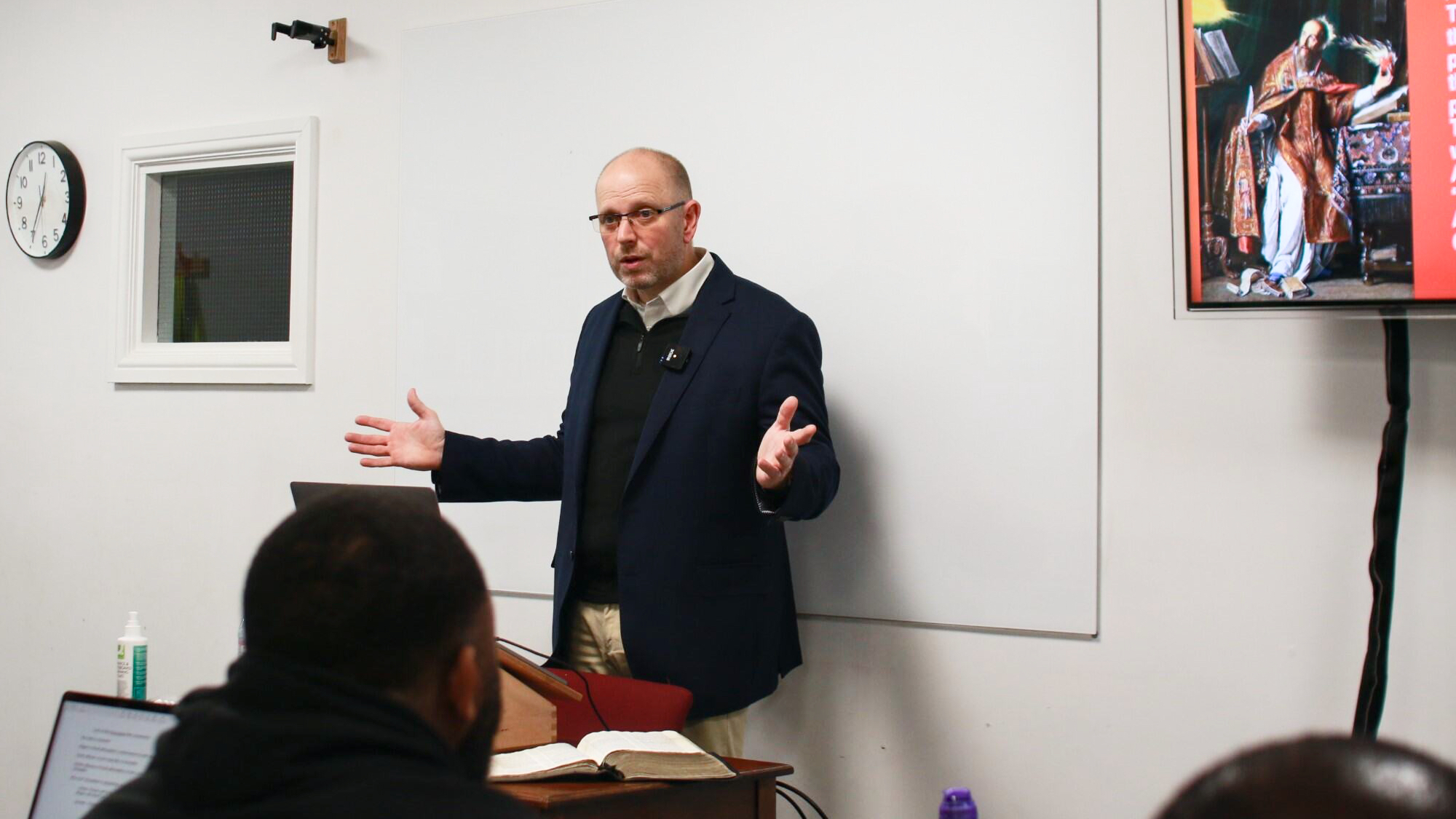 Lecturer. Tom Drion teaching the Hermeneutics class